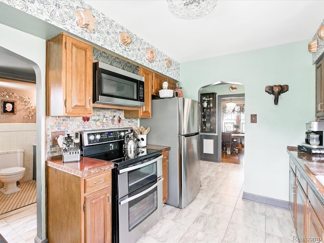 1313 Wall St, Port Huron, MI 48060 - kitchen with appliances with stainless steel finishes and arched walkways