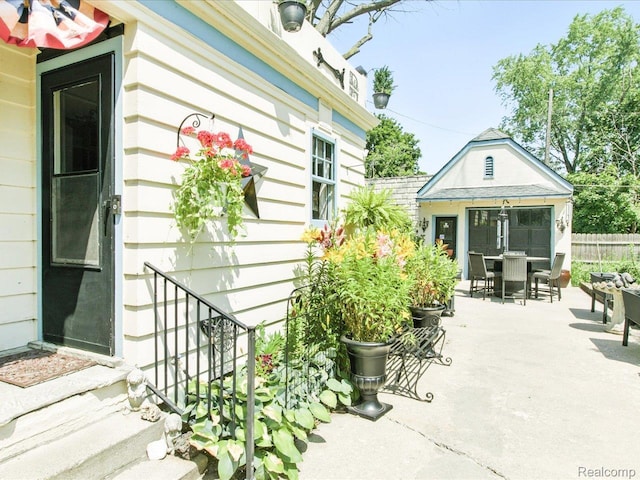 1313 Wall St, Port Huron, MI 48060 - view of patio / terrace with outdoor dining space and an outbuilding