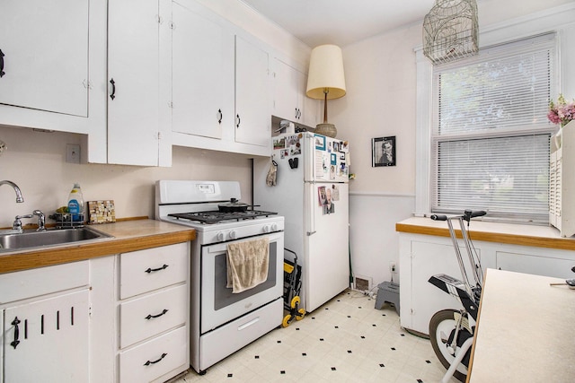 936 W Kalamazoo Ave, Kalamazoo, MI 49007 - kitchen with white appliances, white cabinetry, light floors, and light countertops