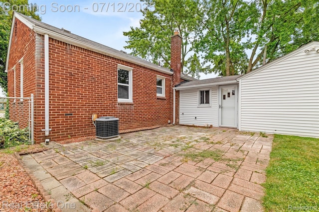 14268 Trenton Rd, Southgate, MI 48195 - rear view of property featuring brick siding, a patio, and a chimney