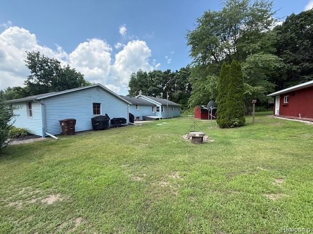 3103 Roush Rd, Hastings, MI 49058 - view of grassy yard featuring a shed