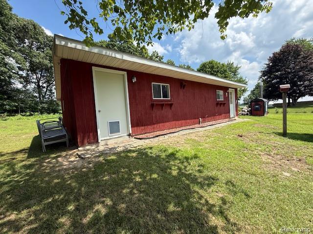 3103 Roush Rd, Hastings, MI 49058 - rear view of property featuring an outdoor structure and a yard