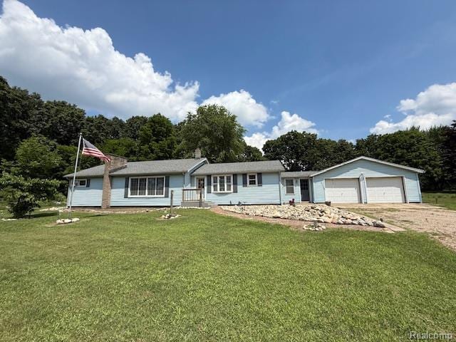 3103 Roush Rd, Hastings, MI 49058 - single story home featuring dirt driveway, a front lawn, and a garage