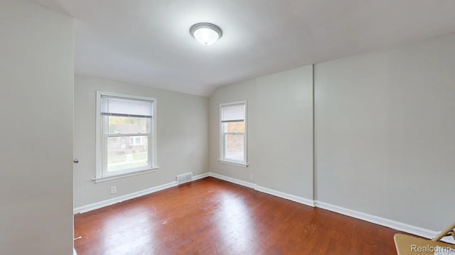 10800 Stratman St, Detroit, MI 48224 - spare room featuring wood finished floors and vaulted ceiling