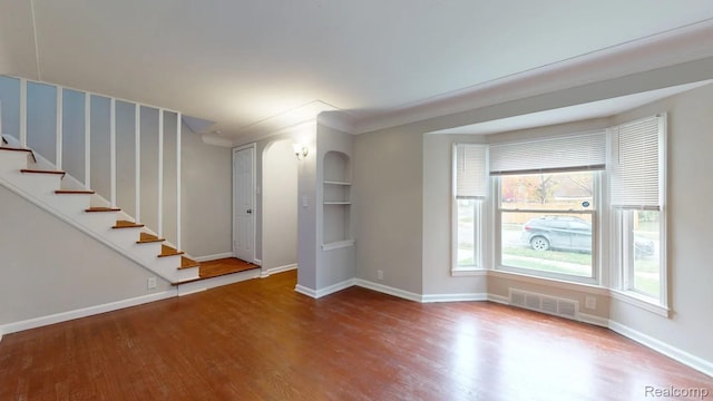 10800 Stratman St, Detroit, MI 48224 - spare room featuring wood finished floors and stairs