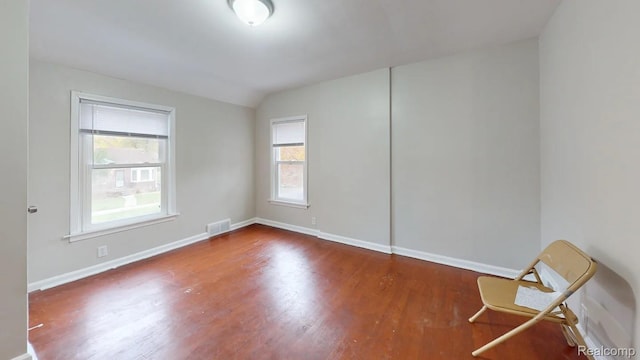 10800 Stratman St, Detroit, MI 48224 - unfurnished room featuring wood finished floors and vaulted ceiling