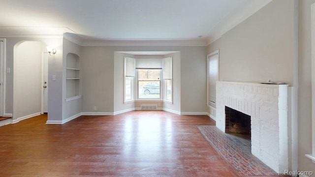 10800 Stratman St, Detroit, MI 48224 - unfurnished living room with wood finished floors, a brick fireplace, ornamental molding, and built in shelves