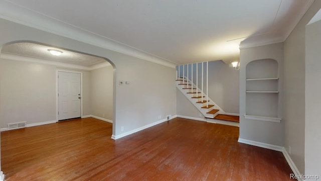 10800 Stratman St, Detroit, MI 48224 - unfurnished room featuring arched walkways, wood finished floors, stairway, and crown molding