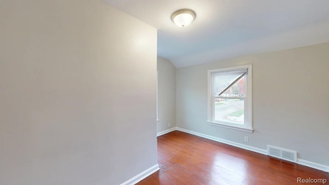 10800 Stratman St, Detroit, MI 48224 - unfurnished room featuring lofted ceiling and wood finished floors