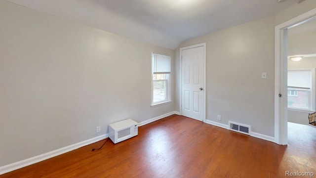 10800 Stratman St, Detroit, MI 48224 - unfurnished room featuring wood finished floors, plenty of natural light, and vaulted ceiling