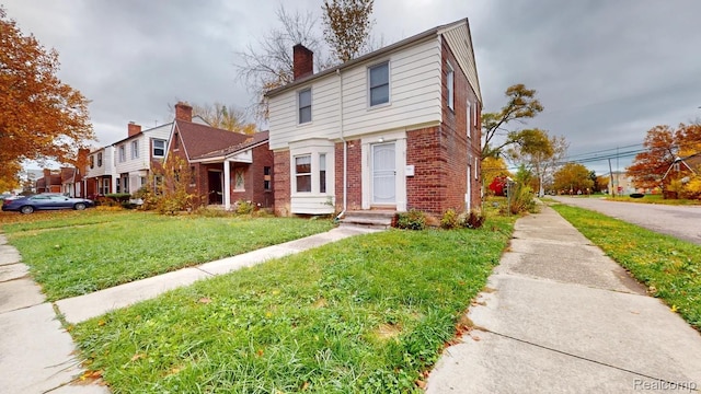 10800 Stratman St, Detroit, MI 48224 - view of front of property with brick siding, a front lawn, and a chimney