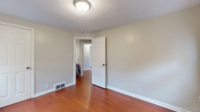 10800 Stratman St, Detroit, MI 48224 - unfurnished bedroom featuring wood finished floors and baseboards