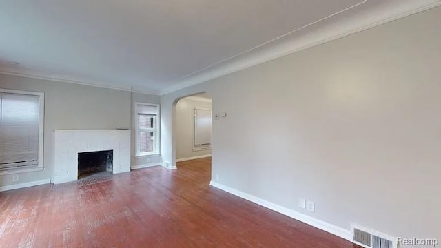 10800 Stratman St, Detroit, MI 48224 - unfurnished living room featuring arched walkways, wood finished floors, ornamental molding, and a fireplace