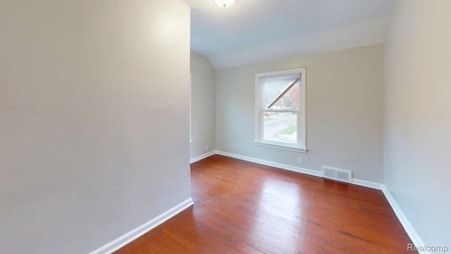 10800 Stratman St, Detroit, MI 48224 - spare room featuring wood finished floors and lofted ceiling