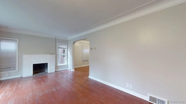 10800 Stratman St, Detroit, MI 48224 - unfurnished living room with arched walkways, wood finished floors, crown molding, and a brick fireplace