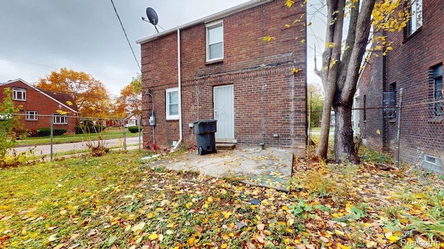 10800 Stratman St, Detroit, MI 48224 - back of house featuring brick siding and a patio