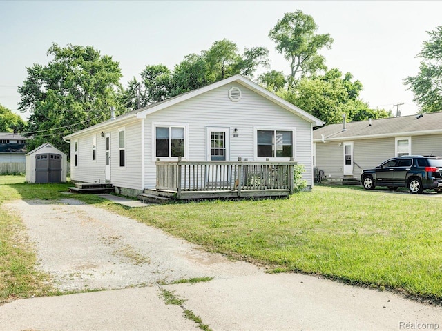 1114 Union St, Port Huron, MI 48060 - view of front of home featuring a storage shed, a deck, and a front yard