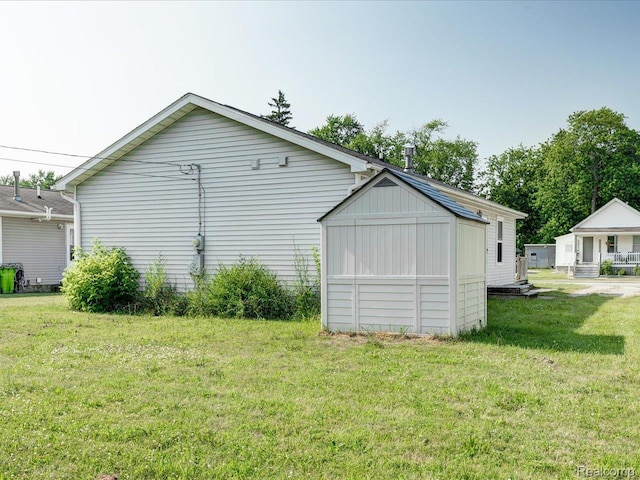1114 Union St, Port Huron, MI 48060 - view of side of home featuring a lawn and a storage unit