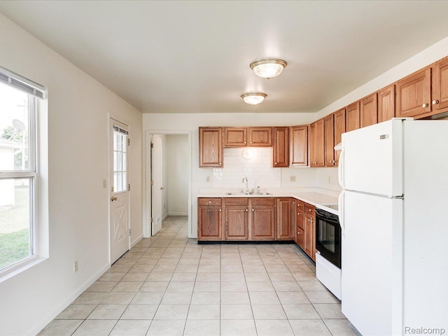 1114 Union St, Port Huron, MI 48060 - kitchen featuring freestanding refrigerator, electric range oven, plenty of natural light, and light countertops