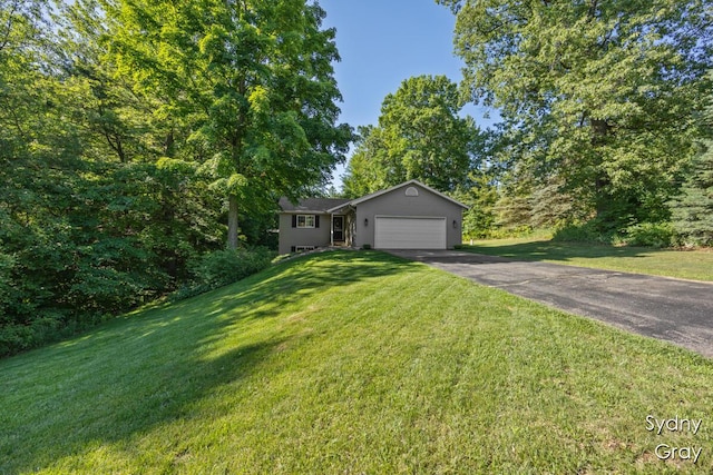 11200 Ivory Valley Dr NE, Rockford, MI 49341 - ranch-style home featuring driveway, an attached garage, and a front yard