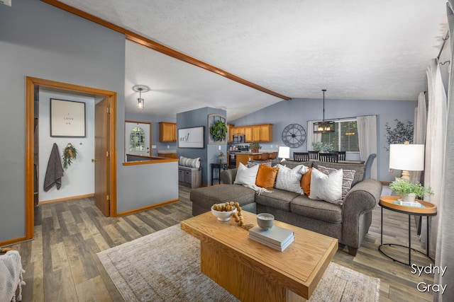 11200 Ivory Valley Dr NE, Rockford, MI 49341 - living room featuring vaulted ceiling and wood finished floors