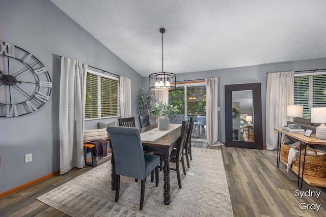 11200 Ivory Valley Dr NE, Rockford, MI 49341 - dining space with a chandelier, wood finished floors, and lofted ceiling