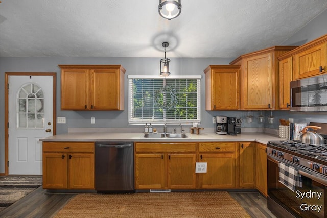 11200 Ivory Valley Dr NE, Rockford, MI 49341 - kitchen featuring appliances with stainless steel finishes, dark wood-style flooring, and light countertops
