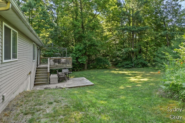 11200 Ivory Valley Dr NE, Rockford, MI 49341 - view of green lawn with stairs and a deck