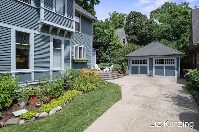 120 Union Ave SE, Grand Rapids, MI 49503 - view of side of home featuring an outbuilding, a garage, and a shingled roof