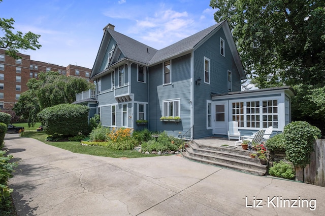 120 Union Ave SE, Grand Rapids, MI 49503 - rear view of property with a chimney and a sunroom