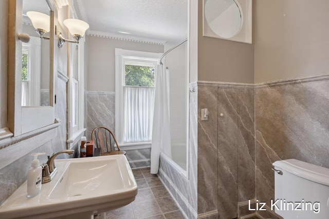 120 Union Ave SE, Grand Rapids, MI 49503 - bathroom with tile walls, shower / bathtub combination with curtain, tile patterned flooring, wainscoting, and a textured ceiling