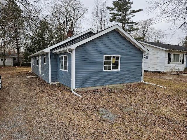 538 Whitney Ave, Morenci, MI 49256 - view of side of home featuring a chimney