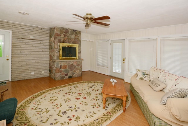 2357 River St, Kalamazoo, MI 49048 - living room with ceiling fan, wood finished floors, brick wall, and a fireplace