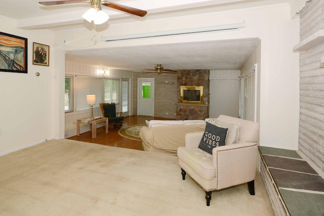 2357 River St, Kalamazoo, MI 49048 - living room featuring ceiling fan, a fireplace, beamed ceiling, and wood finished floors