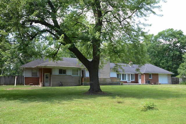2357 River St, Kalamazoo, MI 49048 - back of house with brick siding, a garage, and a chimney