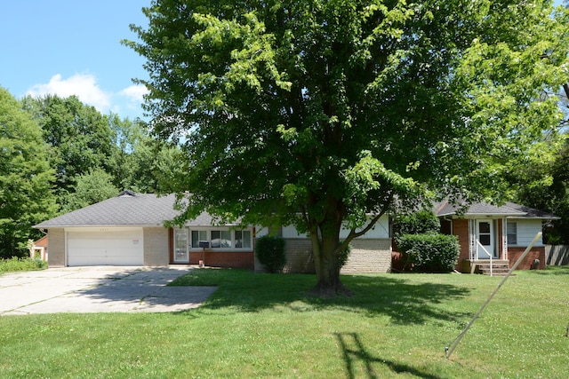 2357 River St, Kalamazoo, MI 49048 - view of front of house with brick siding, a garage, concrete driveway, and a front yard