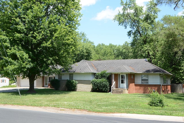 2357 River St, Kalamazoo, MI 49048 - ranch-style house with brick siding, a front yard, and an attached garage