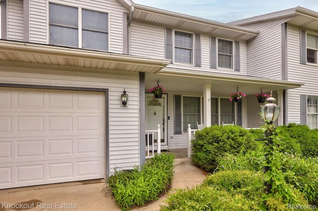 622 W Schleier St, Frankenmuth, MI 48734 - view of front facade featuring covered porch and a garage