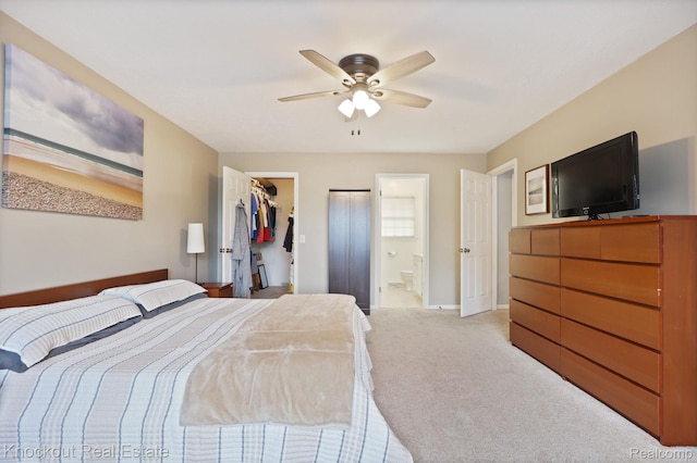 622 W Schleier St, Frankenmuth, MI 48734 - bedroom with a walk in closet, light carpet, a closet, a ceiling fan, and ensuite bathroom