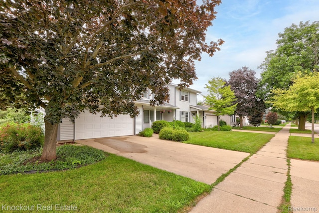 622 W Schleier St, Frankenmuth, MI 48734 - obstructed view of property with concrete driveway, a front lawn, and an attached garage