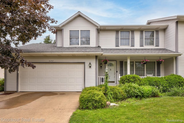 622 W Schleier St, Frankenmuth, MI 48734 - traditional-style house with covered porch, driveway, a garage, and a front lawn