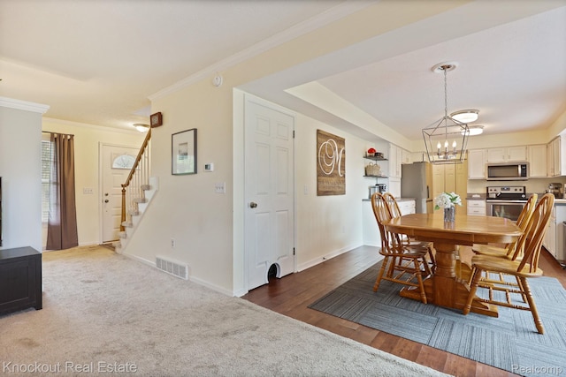 622 W Schleier St, Frankenmuth, MI 48734 - dining area with a chandelier, stairway, ornamental molding, and wood finished floors