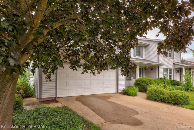 622 W Schleier St, Frankenmuth, MI 48734 - obstructed view of property with concrete driveway and a porch