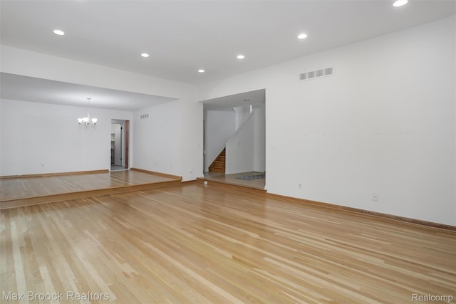 5844 Independence Ln, West Bloomfield, MI 48322 - spare room featuring a chandelier, light wood-style flooring, stairway, and recessed lighting