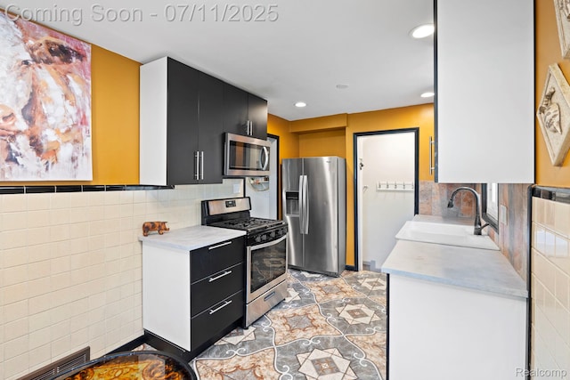 24528 Schroeder Ave, Eastpointe, MI 48021 - kitchen with stainless steel appliances, dark cabinetry, light countertops, recessed lighting, and tile walls