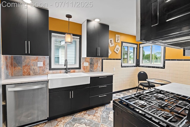 24528 Schroeder Ave, Eastpointe, MI 48021 - kitchen with stainless steel dishwasher, dark cabinetry, gas stove, light countertops, and tile walls
