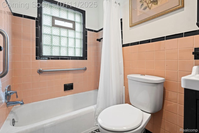 24528 Schroeder Ave, Eastpointe, MI 48021 - full bath with tile walls, shower / bath combo with shower curtain, and wainscoting