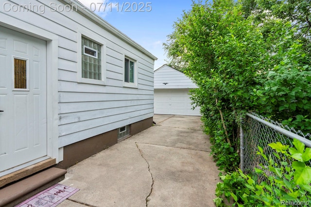 24528 Schroeder Ave, Eastpointe, MI 48021 - view of patio with an outdoor structure, entry steps, and a detached garage