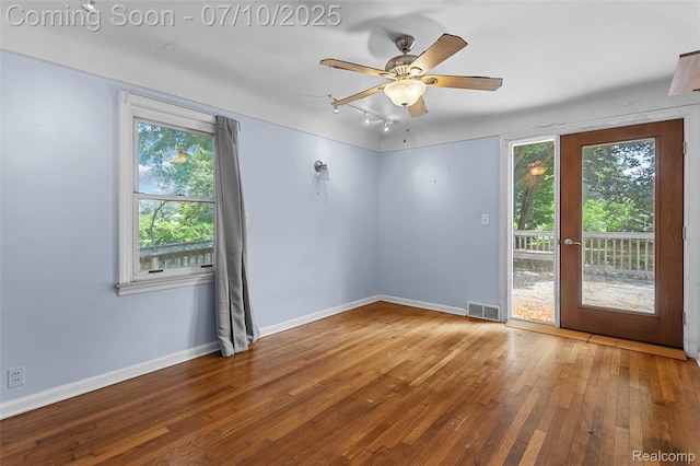 18930 Deering St, Melvindale, MI 48152 - empty room with wood-type flooring, a ceiling fan, and rail lighting