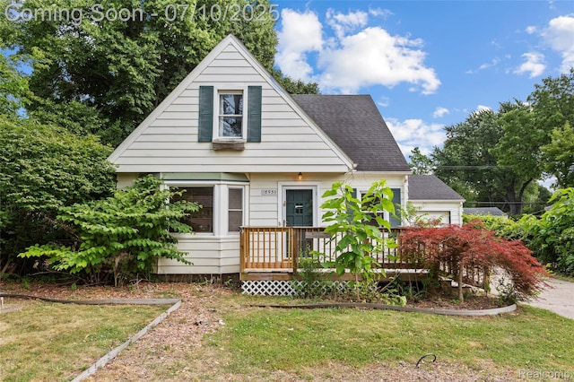 18930 Deering St, Melvindale, MI 48152 - view of front facade with a front yard, roof with shingles, and a wooden deck